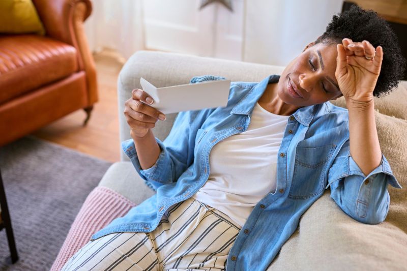 Women on couch experiencing hot flashes