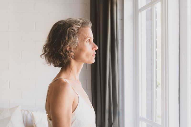 Woman looking out window