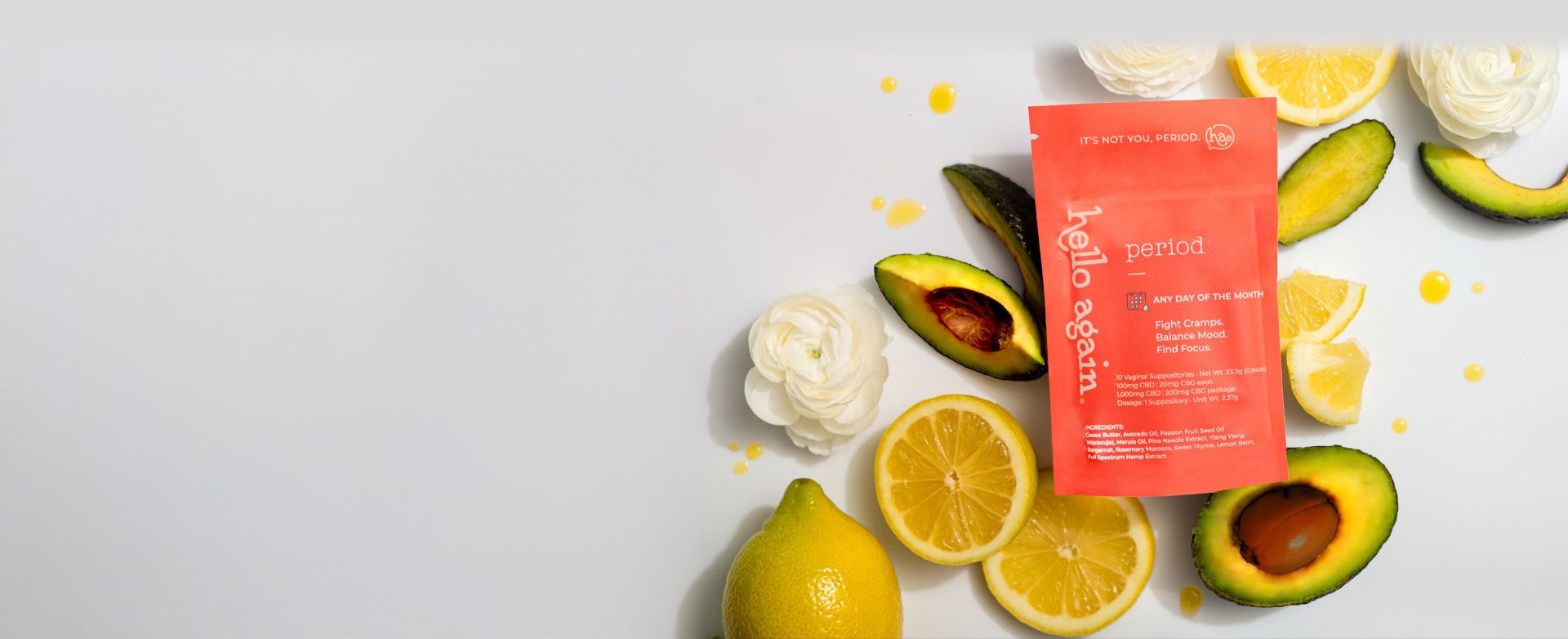 Hello Again Period Product next to flowers, lemons, avocados, and olive oil