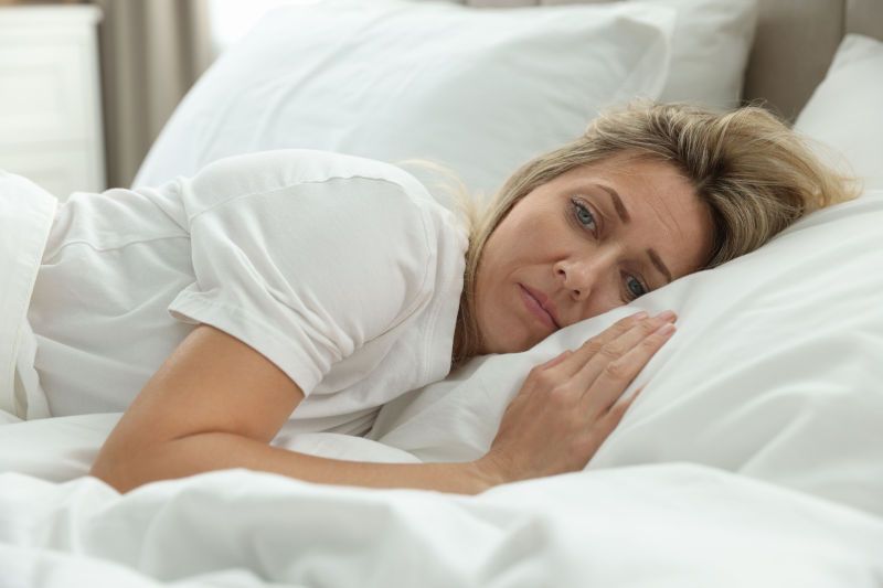 Woman on pillow trying to fall asleep
