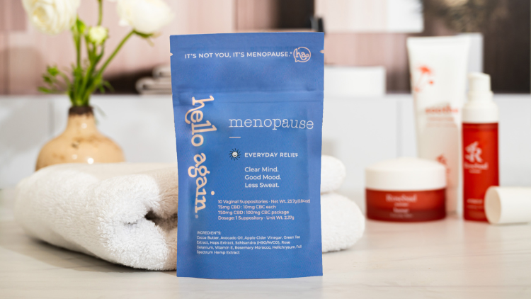 Hello Again Menopause product on a bathroom counter with flowers, a white towel, and Rosebud Woman products.