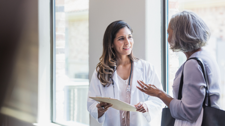 A female patient asks a doctor about perimenopause symptoms.