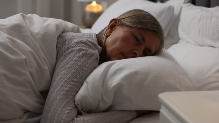 A woman sleeps soundly without Sleep and Menopause symptoms.
