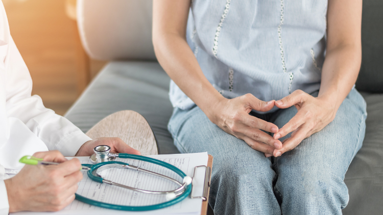 Woman talking to doctor about vaginal dryness.