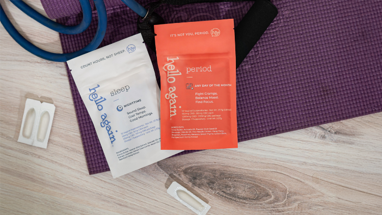 Hello Again Sleep and Period products sit on top of a purple exercise mat.
