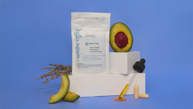 Hello Again Sleep packaging styled with avocado, botanicals, oil dropper, and suppositories on a blue backdrop.