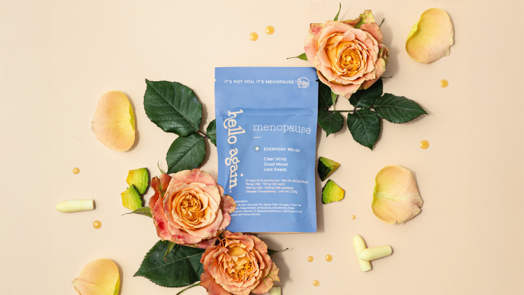 Hello Again Menopause CBD product surrounded by roses and suppositories, highlighting CBD for menopause symptoms.