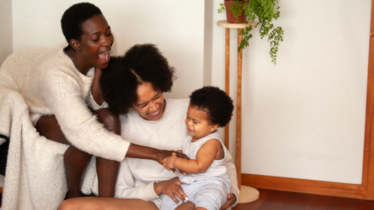Mother and child laughing together at home, reflecting the nurturing role of a matriarch in family life.