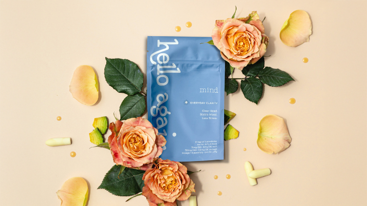 Hello Again Mind CBD + CBC suppositories surrounded by roses, greenery, and scattered petals.