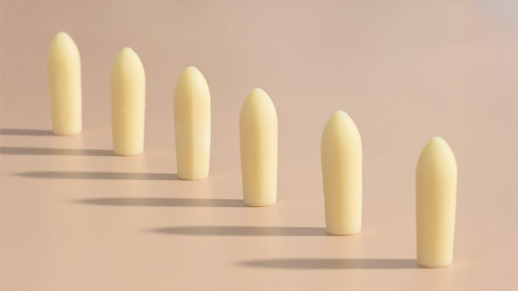 Hello Again vaginal suppositories arranged against a neutral background, illustrating a targeted delivery method for women’s wellness.