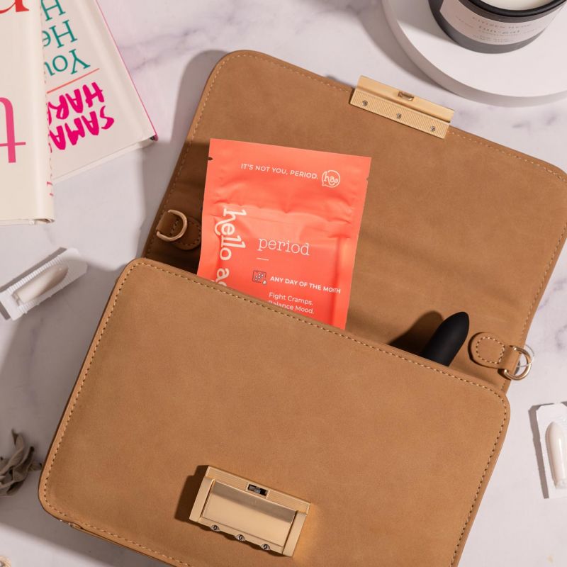 A box of Hello Again Period is displayed with pink roses on a pink backdrop.