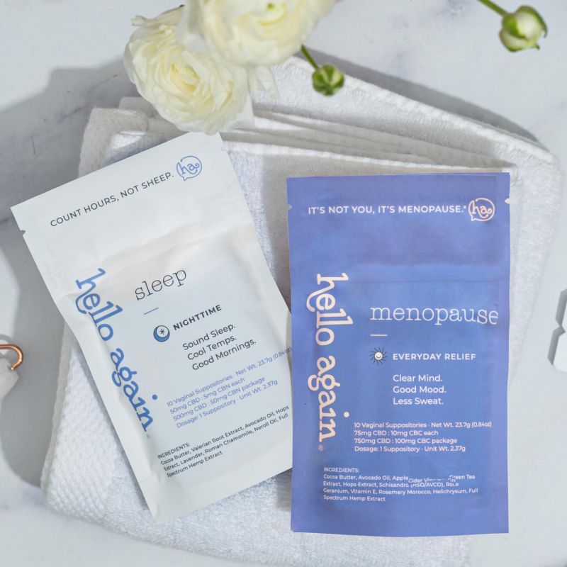 The Sleep product from Hello Again lays on a dark blue background with white and yellow flowers surrounding it.